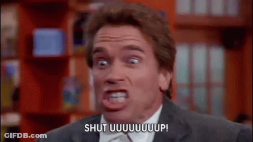 A Man In A Suit And Tie Is Making A Funny Face And Saying Shut Uuuuuuup . GIF