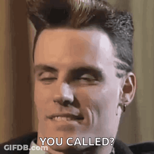 A Man In A Suit And Tie Is Making A Funny Face And Saying You Called . GIF