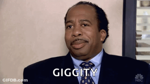 A Man In A Suit And Tie Is Making A Funny Face And Says Giggity . GIF