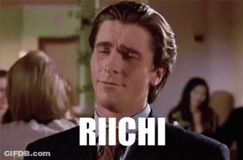 A Man In A Suit And Tie Is Making A Funny Face And The Word Richi Is Written On His Face . GIF