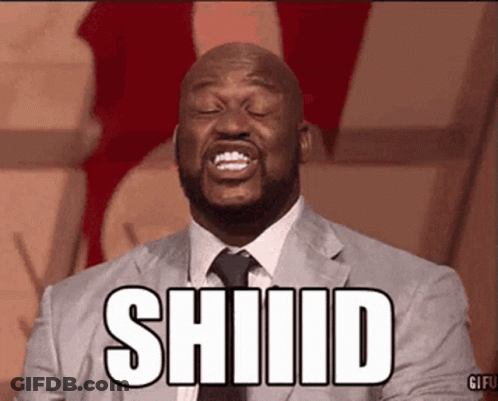 A Man In A Suit And Tie Is Making A Funny Face And The Word Shiiid Is Above Him . GIF