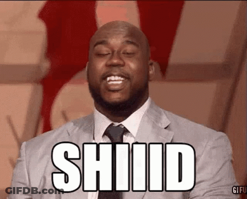 A Man In A Suit And Tie Is Making A Funny Face And The Word Shiiid Is On His Face . GIF