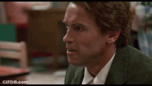 A Man In A Suit And Tie Is Making A Funny Face In A Blurry Photo . GIF