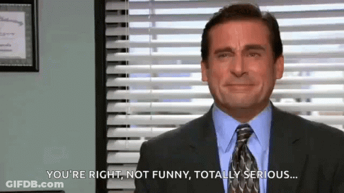 A Man In A Suit And Tie Is Making A Funny Face In Front Of A Window . GIF