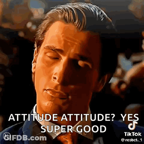 A Man In A Suit And Tie Is Making A Funny Face . GIF