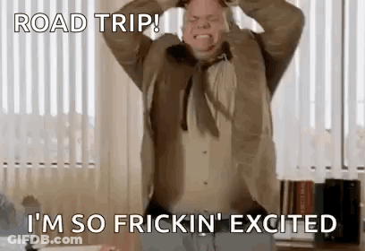 A Man In A Suit And Tie Is Making A Funny Face While Holding His Head . GIF