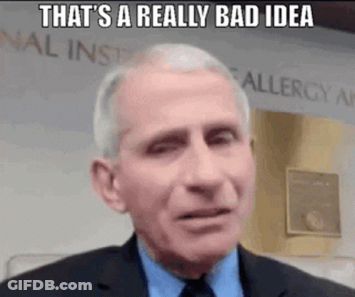 A Man In A Suit And Tie Is Making A Funny Face While Talking . GIF
