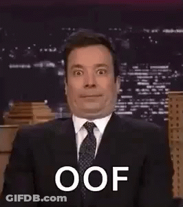 A Man In A Suit And Tie Is Making A Funny Face While Talking On A Talk Show . GIF