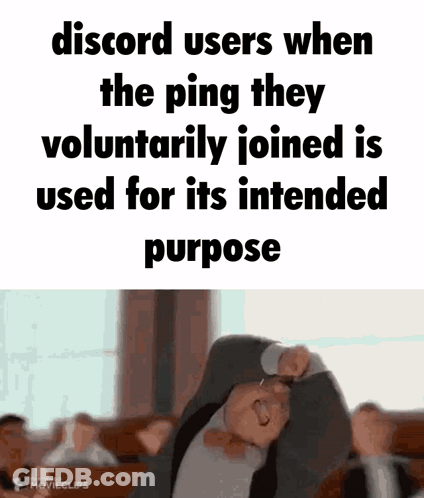 A Man In A Suit And Tie Is Making A Funny Face With His Arms Outstretched . GIF