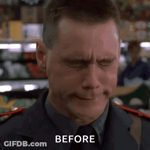 A Man In A Suit And Tie Is Making A Funny Face With His Eyes Closed And The Words Before Written On The Bottom . GIF