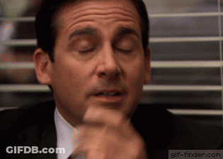 A Man In A Suit And Tie Is Making A Funny Face With His Eyes Closed GIF