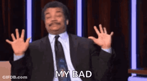 A Man In A Suit And Tie Is Making A Funny Face With His Hands In The Air . GIF