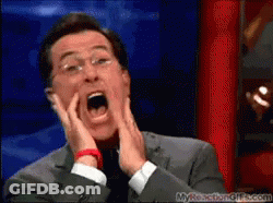 A Man In A Suit And Tie Is Making A Funny Face With His Mouth Open GIF