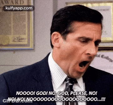 A Man In A Suit And Tie Is Making A Funny Face With His Mouth Wide Open . GIF