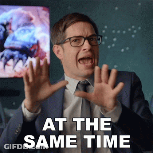 A Man In A Suit And Tie Is Making A Funny Face With The Words At The Same Time Behind Him GIF