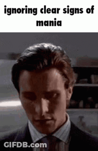 A Man In A Suit And Tie Is Making A Funny Face . GIF