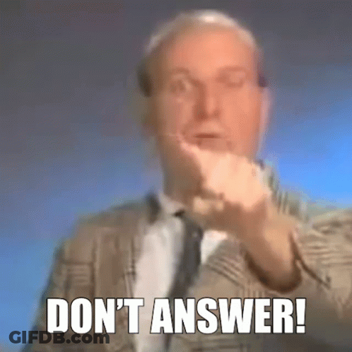 A Man In A Suit And Tie Is Making A Gesture With His Hand And The Words `` Do N't Answer '' . GIF