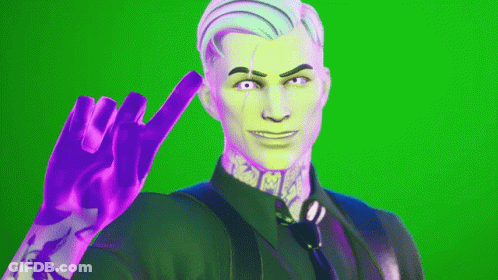 A Man In A Suit And Tie Is Making A Peace Sign GIF