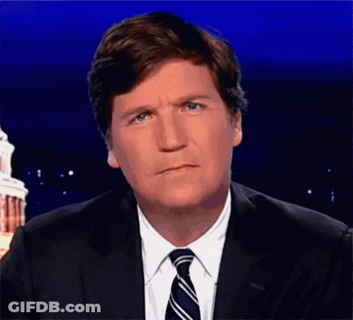 A Man In A Suit And Tie Is Making A Sad Face . GIF