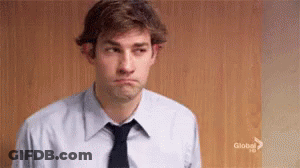 A Man In A Suit And Tie Is Making A Sad Face . GIF