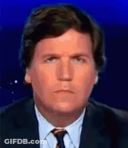 A Man In A Suit And Tie Is Making A Sad Face . GIF