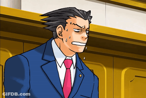 A Man In A Suit And Tie Is Making A Surprised Face GIF