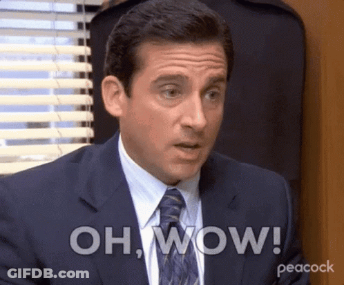 A Man In A Suit And Tie Is Making A Surprised Face And Saying Oh Wow . GIF