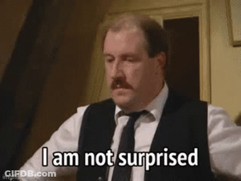 A Man In A Suit And Tie Is Making A Surprised Face . GIF