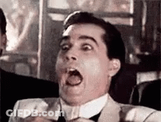 A Man In A Suit And Tie Is Making A Surprised Face With His Mouth Open . GIF