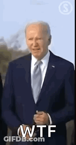A Man In A Suit And Tie Is Making A Wtf Gesture . GIF