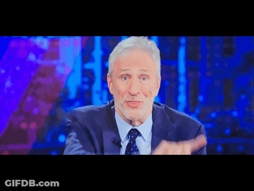 A Man In A Suit And Tie Is On A Television Show GIF
