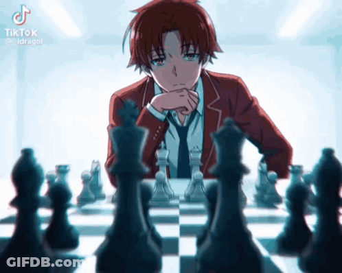 A Man In A Suit And Tie Is Playing A Game Of Chess . GIF
