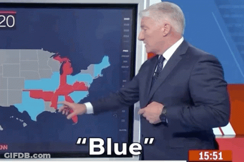 A Man In A Suit And Tie Is Pointing At A Map Of The United States And Says " Blue " GIF