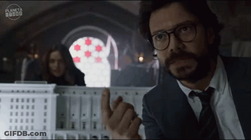 A Man In A Suit And Tie Is Pointing At Something In Front Of A Sign That Says Planeta 000000 GIF