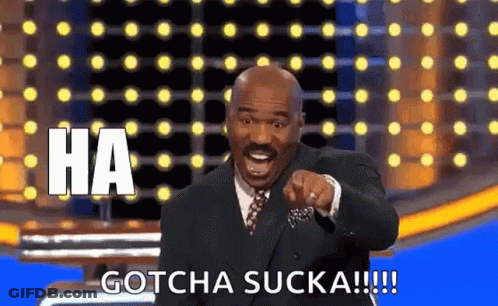 A Man In A Suit And Tie Is Pointing At The Camera And Saying `` Ha Gotcha Sucka '' . GIF