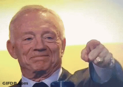 A Man In A Suit And Tie Is Pointing At The Camera With His Finger GIF