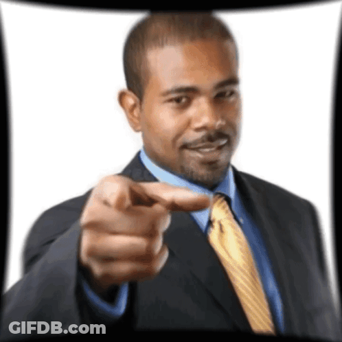 A Man In A Suit And Tie Is Pointing His Finger At The Camera GIF