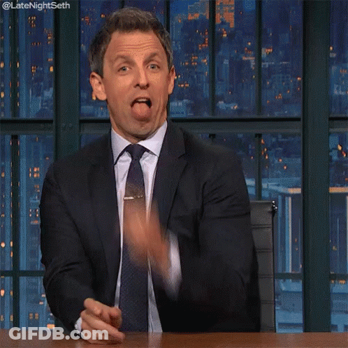 A Man In A Suit And Tie Is Pointing His Finger At The Camera GIF