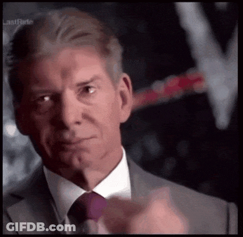 A Man In A Suit And Tie Is Pointing His Finger GIF