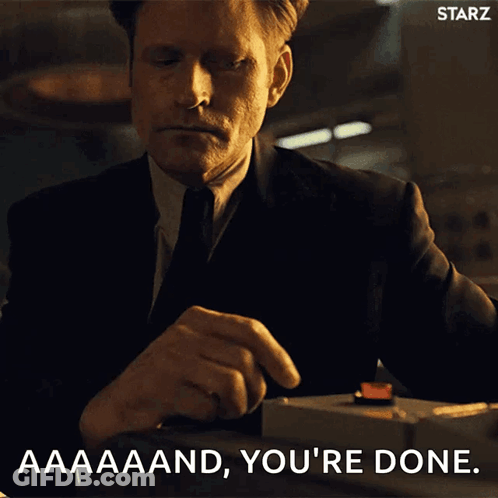 A Man In A Suit And Tie Is Pressing A Red Button And Says " Aaaand You 'Re Done " GIF
