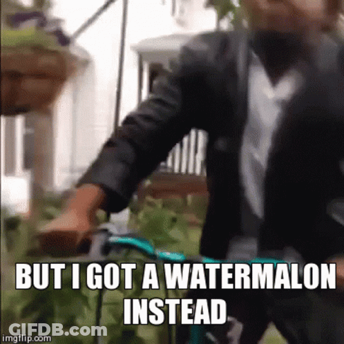 A Man In A Suit And Tie Is Riding A Bike With The Caption But I Got A Watermelon Instead GIF