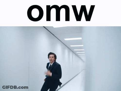 A Man In A Suit And Tie Is Running Down A Hallway With The Word Omw On The Bottom GIF