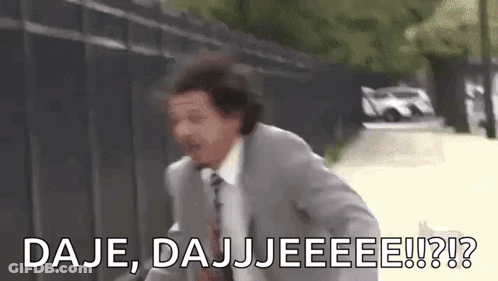 A Man In A Suit And Tie Is Running Down A Street With The Words `` Daje , Dajjeee !! '' . GIF