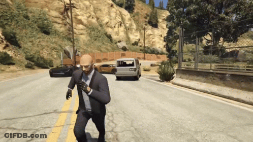 A Man In A Suit And Tie Is Running Down The Road GIF