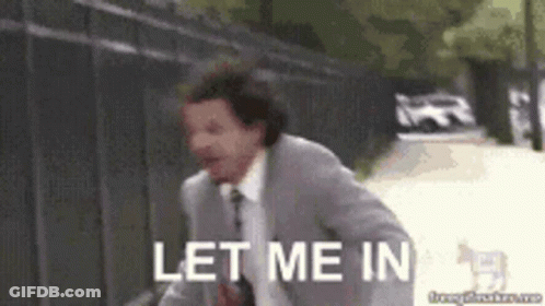 A Man In A Suit And Tie Is Running With The Words Let Me In Behind Him . GIF