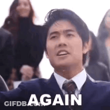A Man In A Suit And Tie Is Saying `` Again '' . GIF