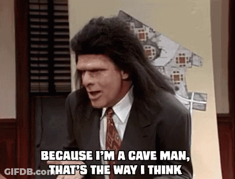 A Man In A Suit And Tie Is Saying `` Because I 'M A Cave Man That 'S The Way I Think '' GIF