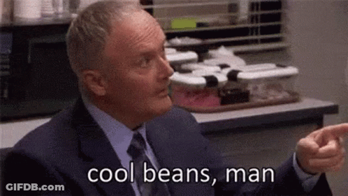 A Man In A Suit And Tie Is Saying `` Cool Beans , Man '' While Pointing . GIF