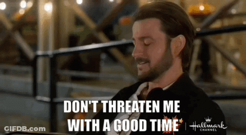 A Man In A Suit And Tie Is Saying " Don 'T Threaten Me With A Good Time " GIF