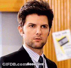 A Man In A Suit And Tie Is Saying " Good Lord " . GIF